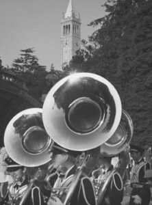 Ansel Adams photograph of Cal marching band with the Sather Tower
